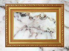 Gold frame Vintage photo frame on marble stone wall background