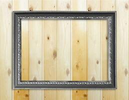 Empty picture frame on wooden wall. photo