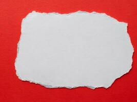 torn paper with space for text on red background photo