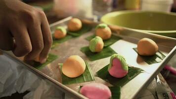 Male hands arrange bread dough on a baking sheet. The movement of a man's hands arranging cakes on a baking sheet. video