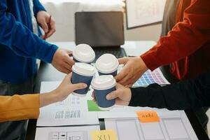 UX developer and ui designer brainstorming about mobile app interface wireframe design with customer breif and color code at modern office. photo