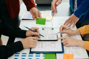 UX developer and ui designer brainstorming about mobile app interface wireframe design with customer breif and color code at modern office. photo