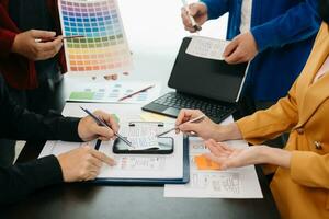 UX developer and ui designer brainstorming about mobile app interface wireframe design with customer breif and color code at modern office. photo