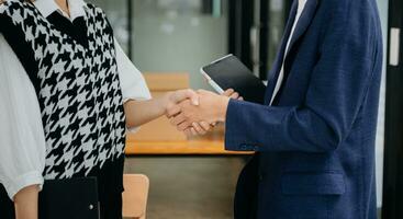 Two confident business man shaking hands during a meeting in the office, success, dealing, greeting and partner in sun light photo