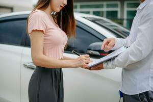 Customers and car insurance agents have entered into agreements and signed documents to claim compensation after a car crash, Insurance concept photo