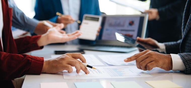 Business team collaboration discussing working analyzing with financial data and marketing growth report graph in team, presentation and digital tablet, laptop photo