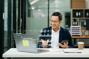 Businessman hand Project manager working and update tasks and Gantt chart scheduling virtual diagram.with smart phone, tablet and laptop in office. photo