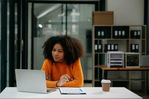 Successful Businesswoman Analyzing Finance on Tablet and Laptop at Office Desk tax, report, accounting, statistics, and analytical research concept photo