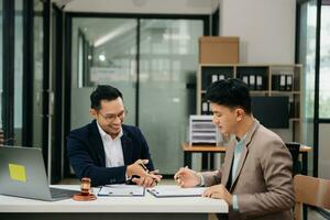 Business and lawyers discussing contract papers with brass scale on desk in office. Law, legal services, advice,  justice and law concept . photo