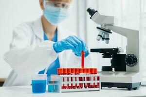 Modern medical research laboratory. female scientist working with micro pipettes analyzing biochemical samples, advanced science chemical laboratory photo