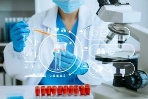 DNA molecule testing concepts. The doctor in a mask examines DNA molecules on the chemical laboratory with virtual icon photo