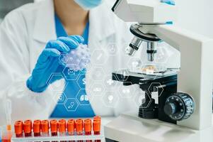 DNA molecule testing concepts. The doctor in a mask examines DNA molecules on the chemical laboratory with virtual icon photo