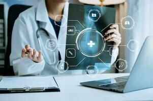 Medicine doctor using digital tablet and smartphone diagnose virtual electronic medical record on interface.Digital healthcare and network on virtual screen photo