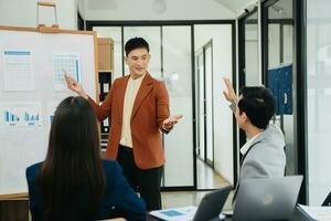 Office colleagues have a casual discussion. During a meeting in a conference room, a group of business teem sit in office room new startup project photo