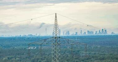 Dronie from a power pole with frankfurt skyline in the background with fast moving clouds after a thunderstorm video