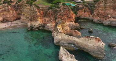 Time lapse drone video over Algarve cliffs near Praia do Prainha beach during daytime