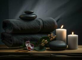 Towel on fern with candles and black hot stone on wooden background. Hot stone massage setting lit by candles. Created with Generative AI technology. photo