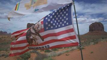 American Flag and Monument Valley, Towering Sandstone Buttes on Navajo Tribal on Arizona - Utah Border USA video