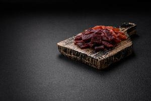 Delicious dried veal or turkey jerky with salt, spices and herbs photo