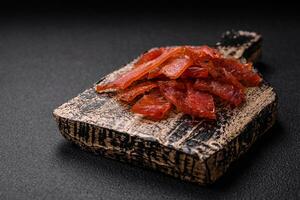 Delicious dried veal or turkey jerky with salt, spices and herbs photo