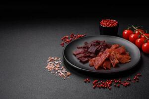 Delicious dried veal or turkey jerky with salt, spices and herbs photo