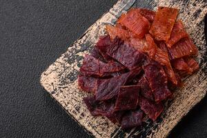 Delicious dried veal or turkey jerky with salt, spices and herbs photo