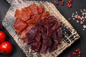 Delicious dried veal or turkey jerky with salt, spices and herbs photo