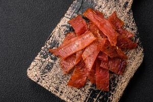 Delicious dried veal or turkey jerky with salt, spices and herbs photo