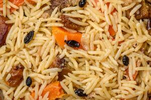 Delicious Uzbek pilaf with chicken, carrots, barberry, spices and herbs photo