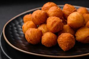 Delicious fried potato balls with breaded mozzarella, salt, spices and herbs photo