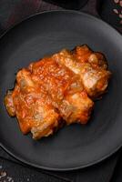 Delicious fresh sea fish cut into pieces and baked in tomato sauce photo