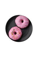 Delicious donut with cream filling and nuts on a dark concrete background photo