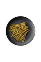 Sprigs of delicious canned asparagus on a black ceramic plate photo