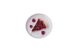 Delicious fragrant sweet pie with cherry berries on a ceramic plate photo