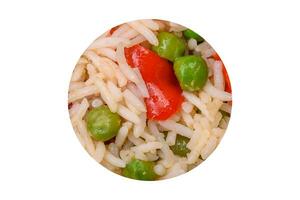 Delicious boiled rice with peppers, peas, asparagus beans and carrots photo