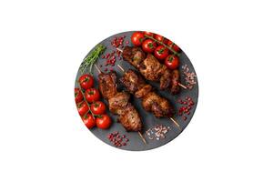 Delicious grilled chicken, turkey or pork skewers with salt, spices and herbs photo