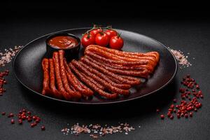 Delicious thin smoked hunting sausages with salt, spices and herbs photo