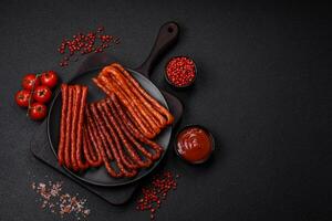 Delicious thin smoked hunting sausages with salt, spices and herbs photo