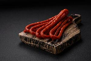 Delicious thin smoked hunting sausages with salt, spices and herbs photo