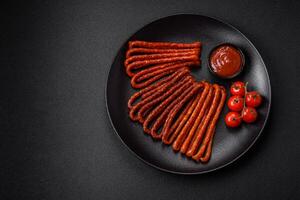 Delicious thin smoked hunting sausages with salt, spices and herbs photo