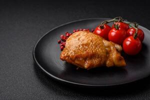 Delicious grilled chicken thighs with salt, spices and herbs photo