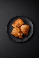 Delicious grilled chicken thighs with salt, spices and herbs photo