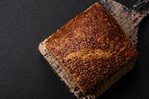 Delicious fresh crispy brown bread with grains and seeds photo