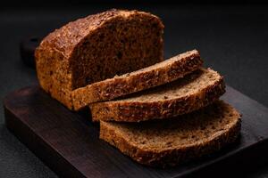 Delicious fresh crispy brown bread with grains and seeds photo