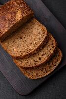 Delicious fresh crispy brown bread with grains and seeds photo