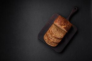 Delicious fresh crispy brown bread with grains and seeds photo