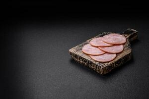 Delicious fresh ham cut into round slices with salt, spices and herbs photo