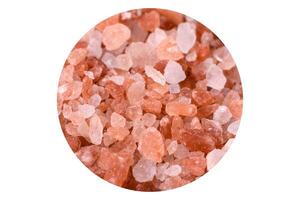 Pink and white large Himalayan salt in a white saucer photo