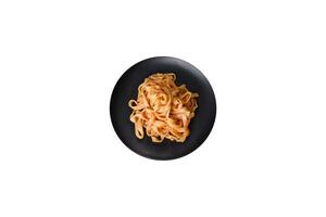 Tasty appetizing pasta tagliatelle spaghetti with tomato sauce and parmesan photo