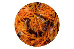 Korean salad with eggplant, carrots, garlic, spices and herbs on a dark concrete background photo